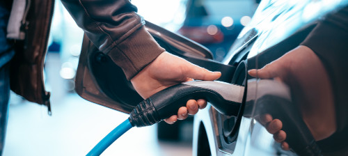 human-hand-is-holding-electric-car-charging-connect-electric-car_4.jpg